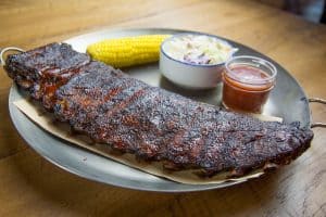 baby back ribs served with corn on the cob, coleslaw, barbecue sauce